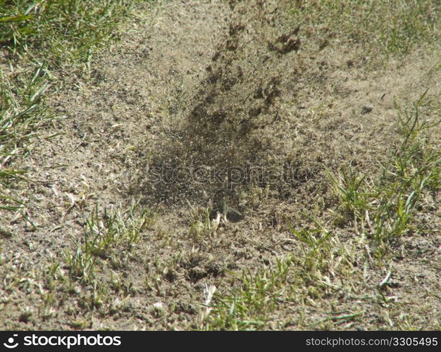 earth flying after a golfer hit the ball