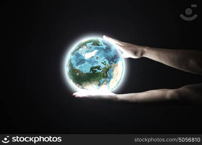 Earth planet. Close up of human hand holding Earth planet. Elements of this image are furnished by NASA