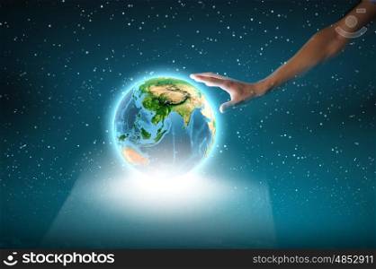 Earth planet. Close up of human hand touching Earth planet. Elements of this image are furnished by NASA