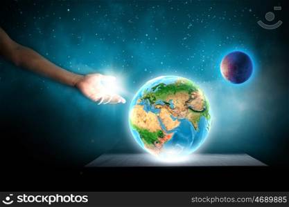 Earth planet. Close up of human hand touching Earth planet with finger. Elements of this image are furnished by NASA