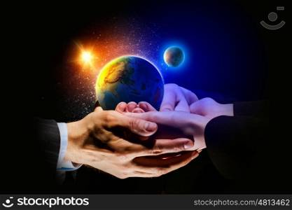 Earth planet in hands. Close up image of human hands holding earth planer. Ecology concept