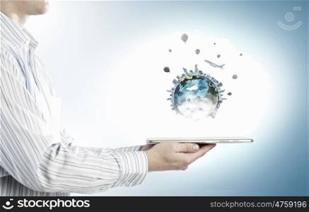 Earth planet on tablet pc. Businessman hands holding tablet pc with Earth planet on it. Elements of this image are furnished by NASA