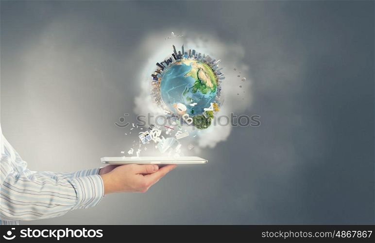 Earth planet on tablet pc. Businessman hands holding tablet pc with Earth planet on it. Elements of this image are furnished by NASA
