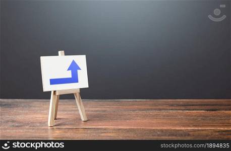 Easel with a blue right up arrow. Direction to go around. Bypassing obstacles and solving problems. Alternative way, fallback. To attract attention. Advertising sign, marketing. Copy space