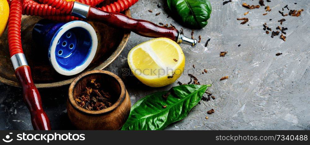 East hookah with fruit aroma for relax.Shisha hookah.Hookah with lemon. Smoking hookah with lemon flavor