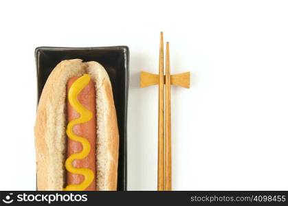 East Meets West - Hot Dog and Chopsticks Isolated on a White Background