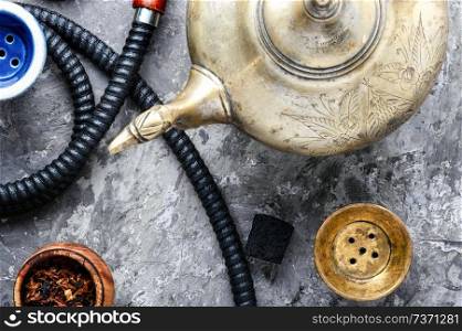 East smoking hookah. Arabian shisha with tea. Hookah and tea.Cooking hookah. Oriental hookah with tea
