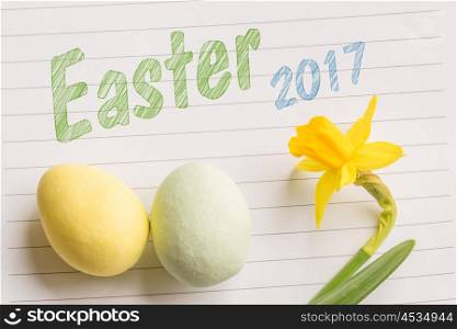 Easter 2017 greeting with daffodils and easter eggs on linear paper