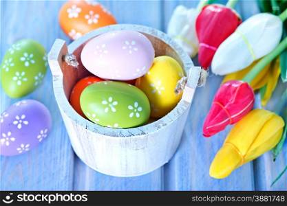 easter background, easter eggs and flowers on a table