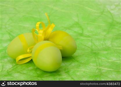 Easter background. Easter eggs and flowers on green sisal background, selective DOF.