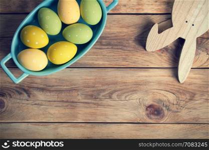 Easter background with Easter eggs and bunny. Top view. Copy space