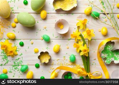 Easter background with easter eggs and spring flowers. Top view