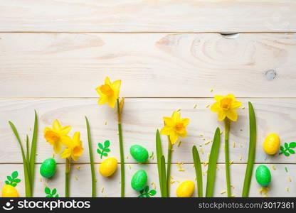 Easter background with easter eggs and spring flowers. Top view with copy space