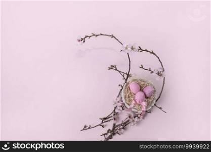 Easter background with Easter eggs with pink ribbon and spring flowers. Top view with copy space. selective focus. Art Easter egg with pink ribbon and spring flowers