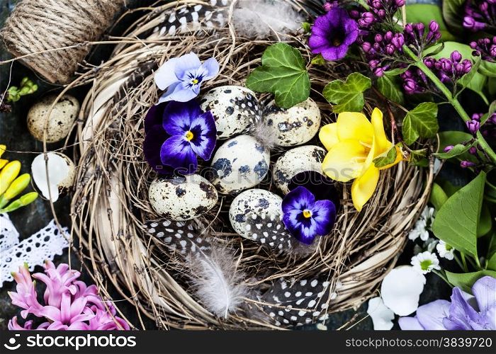 Easter background with eggs, nest and flowers