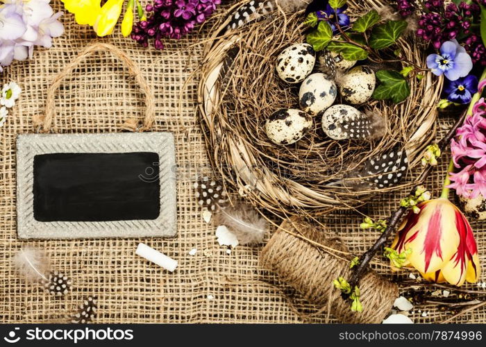 Easter background with eggs, nest and flowers