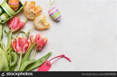 Easter background with fresh tulips, decor eggs and tag, top view, place for text