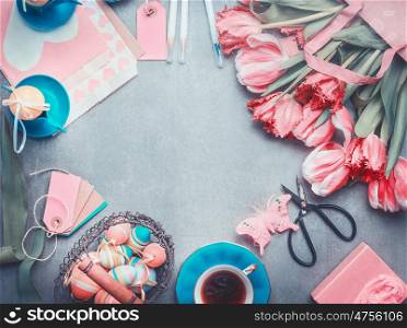 Easter background with tulips bunch, eggs and decoration in pastel color, top view