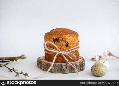 Easter baking. Quail eggs lie near the Easter cake with a ribbon on a wooden stand. Pie with raisins. Festive meal. Dessert biscuit with raisins. Easter baking. Quail eggs lie near the Easter cake with a ribbon on a wooden stand. Raisin Pie