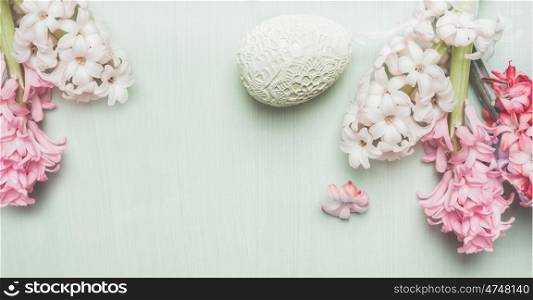 Easter banner with hyacinths and decor egg on light pastel wooden background, top view, place for text