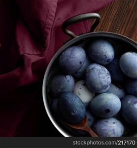 easter blue eggs in a copper pan with burgundy apron. Eggs in pan