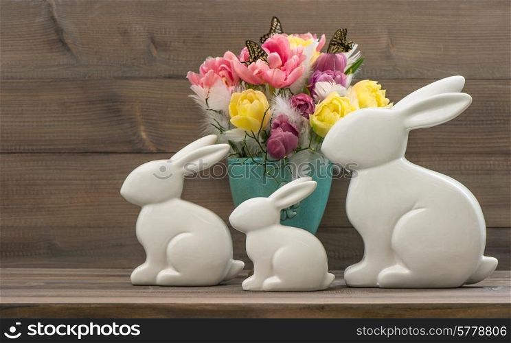 Easter bunnies with tulips flowers. Vintage style toned picture