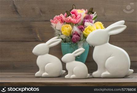 Easter bunnies with tulips flowers. Vintage style toned picture
