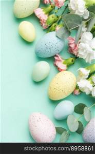 Easter colored eggs and a bouquet of white and pink carnations with eucalyptus branches on a soft green background. Festive background.