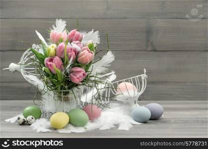 easter composition with eggs and pastel tulip flowers. nostalgic home interior. retro style colored picture