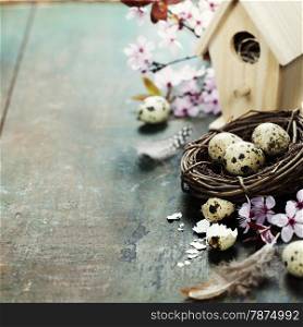 Easter composition with little birdhouse and Cherry Blossom branches