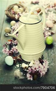 Easter composition with little watering can and Cherry Blossom branches
