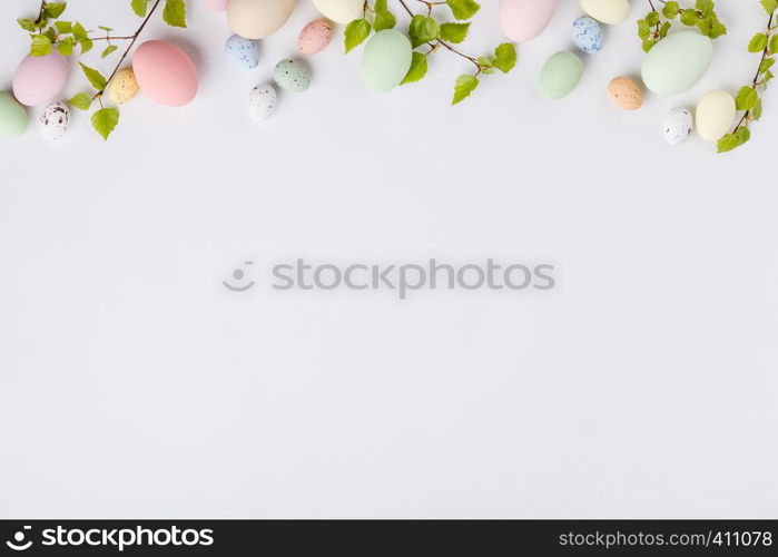 Easter composition with spring branches and eggs on white backgrount, flat lay, top view. Easter composition on white backgrount, top view