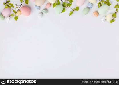 Easter composition with spring branches and eggs on white backgrount, flat lay, top view. Easter composition on white backgrount, top view