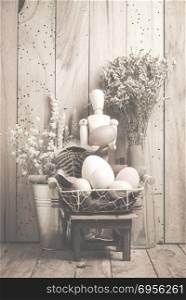 Easter concept with eggs on a wooden background, vintage filtered Images