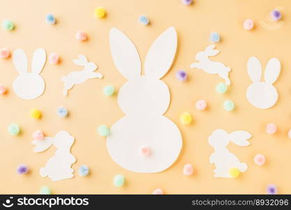 Easter Day Concept. Top view handmade white paper rabbit cutting isolated on pastel background with copy space for your text, Happy Easter Bunny holiday
