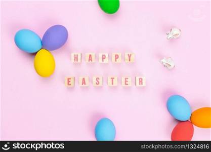 Easter day little Bunny rabbit with decorated eggs on pink background