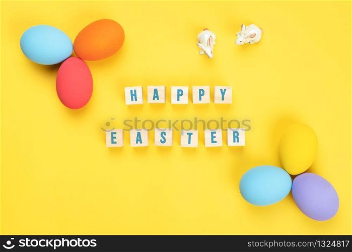 Easter day little Bunny rabbit with decorated eggs on yellow background