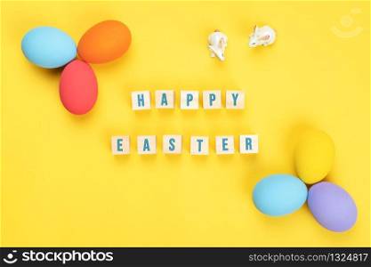 Easter day little Bunny rabbit with decorated eggs on yellow background
