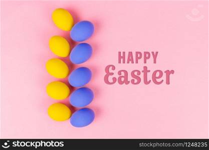 Easter day with decorated eggs on pink background