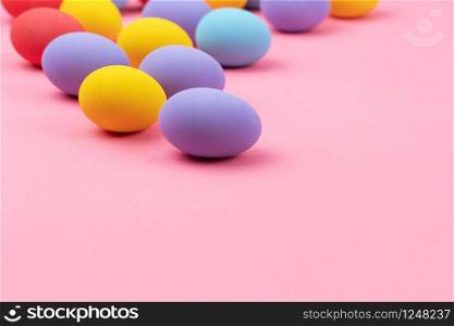 Easter day with decorated eggs on pink background