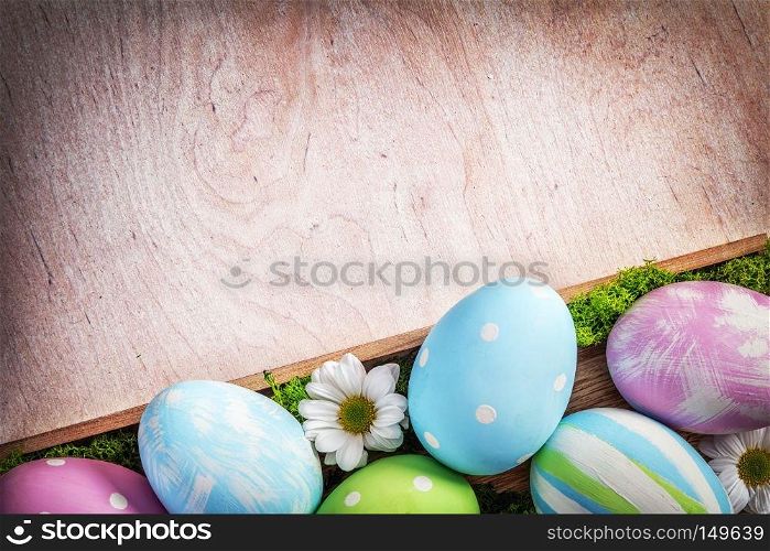 Easter decoration - eggs and flowers on a wood. Holiday time. Easter decoration - eggs and flowers on a wood