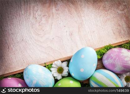 Easter decoration - eggs and flowers on a wood. Holiday time. Easter decoration - eggs and flowers on a wood