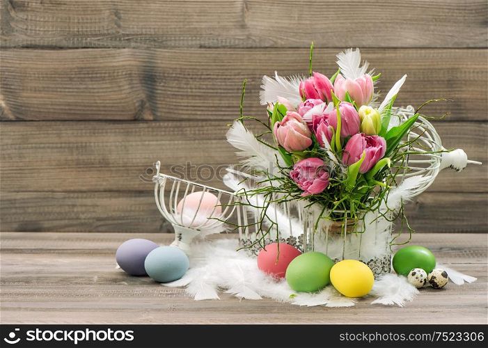 Easter decoration eggs and pink tulip flowers. Romantic home interior. Retro style colored picture