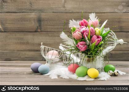 Easter decoration eggs and pink tulip flowers. Romantic home interior. Retro style colored picture