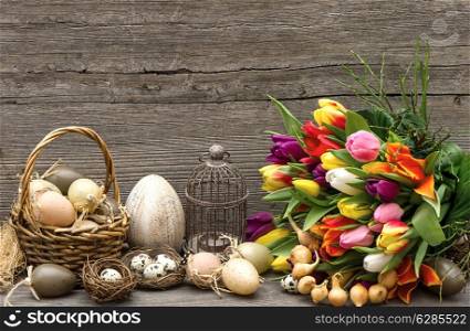 easter decoration with eggs and tulip flowers. nostalgic still life. vintage style picture