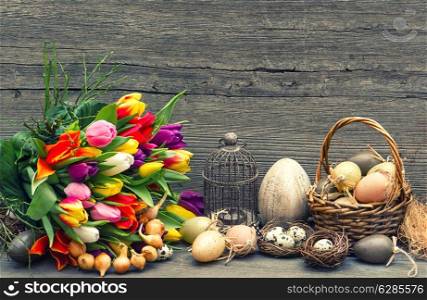 easter decoration with eggs and tulip flowers. nostalgic still life. vintage style toned picture