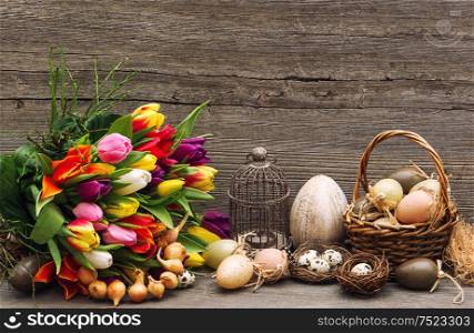 Easter decoration with eggs and tulip flowers. Nostalgic still life. Vintage toned