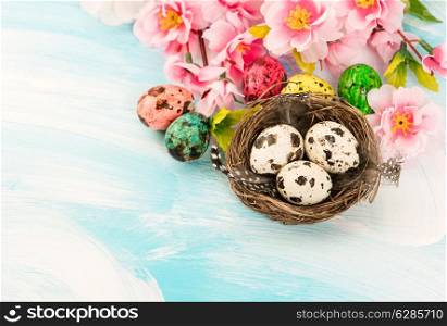 Easter decoration with flowers and eggs in nest. Festive composition