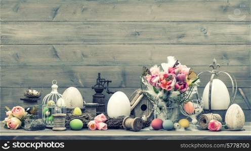 easter decoration with pink tulip flowers and colored eggs. vintage style toned picture