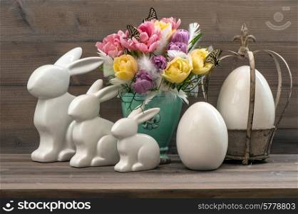 Easter decoration with tulips, eggs and rabbits. Vintage style toned picture